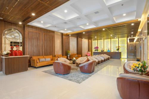 a lobby with couches and chairs in a building at Gold Plaza Hotel Da Nang in Da Nang