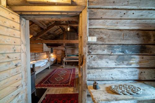 an attic room with a bed in a wooden cabin at Håholmen - by Classic Norway Hotels in Karvåg