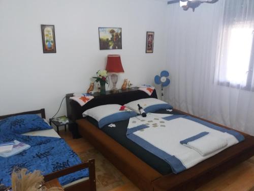 a bedroom with two beds and a window at Traianov most in Kladovo