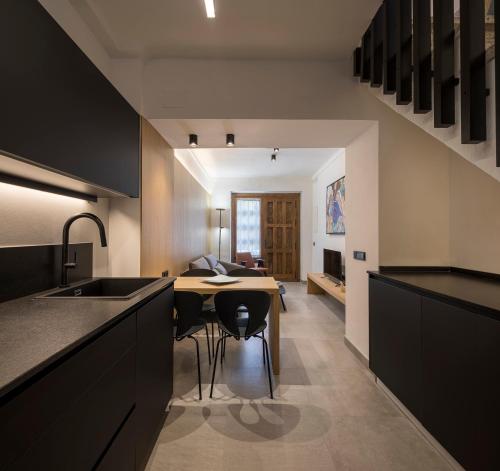 a kitchen with a table and a dining room at LA ALMACERÍA DE ANTEQUERA in Antequera