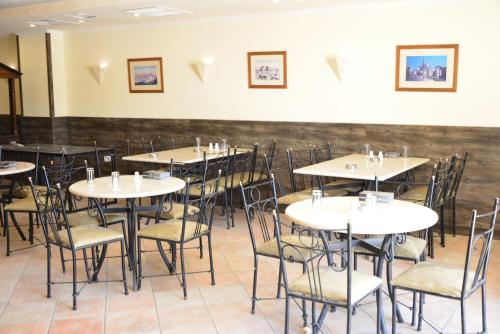a dining room filled with tables and chairs at Rakeen Hotel in Amman