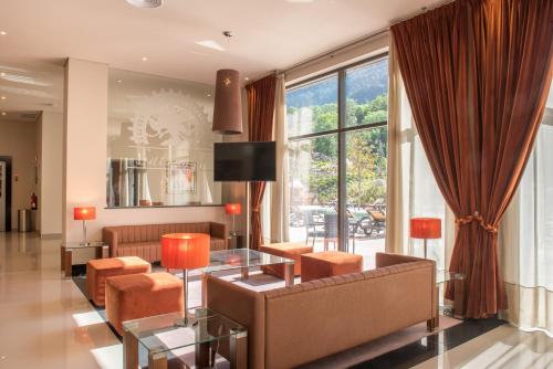 a living room with a couch and a table at Vila Gale Serra da Estrela in Manteigas