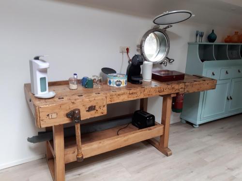 a wooden table with a mirror on top of it at Rooms on Water in Rotterdam