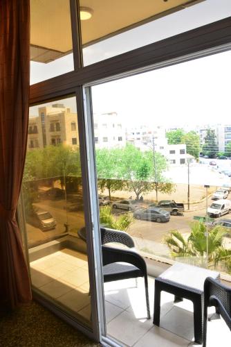 a window with a view of a parking lot at Rakeen Hotel in Amman
