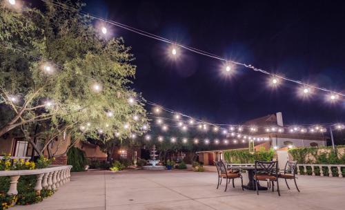 a patio with lights and chairs at night at El Amador Inn Downtown Tucson in Tucson