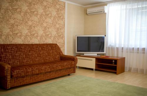 a living room with a couch and a television at Apartments near Gogol theater in Poltava