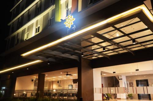 a building with a christmas star on the side of it at Lynn Hotel Serang in Serang