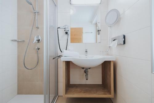 a bathroom with a sink and a shower at Hotel Silberfux in Sankt Veit im Pongau