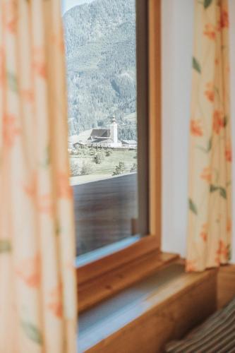 a window with a view of a lighthouse at Hotel Silberfux in Sankt Veit im Pongau