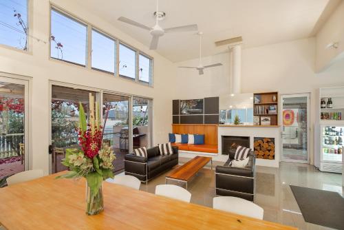 a living room with a table with a vase of flowers at The Horatio Motel Mudgee in Mudgee