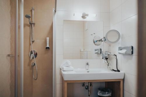 a bathroom with a sink and a shower at Hotel Silberfux in Sankt Veit im Pongau