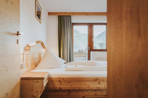 a hotel room with a bed and a window at Hotel Silberfux in Sankt Veit im Pongau