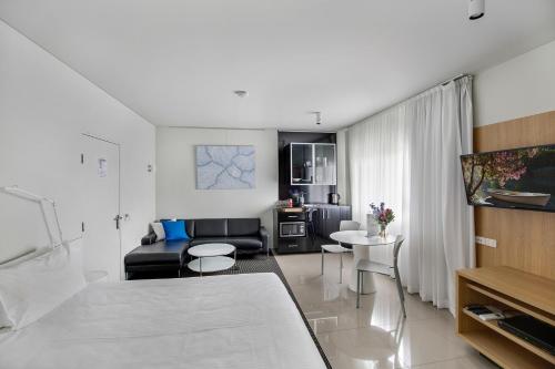 a living room with a couch and a table at The Horatio Motel Mudgee in Mudgee