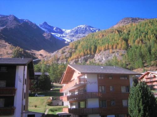 a apartment building with mountains in the background at Apartment La Montanara by Interhome in Saas-Fee