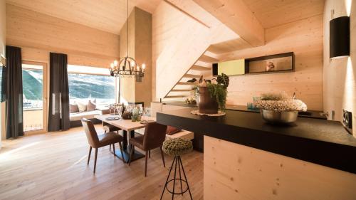 a kitchen and dining room with a table and chairs at Hotel Jagdschloss Resort in Kühtai