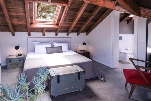 a bedroom with a large bed with a wooden ceiling at Hotel Pop Alaçatı in Alaçatı