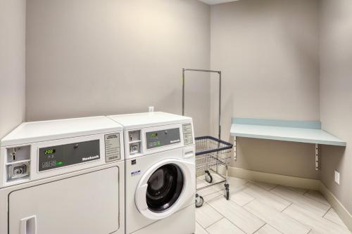 a washer and dryer in a laundry room at Holiday Inn Express & Suites - Charlotte - South End by IHG in Charlotte