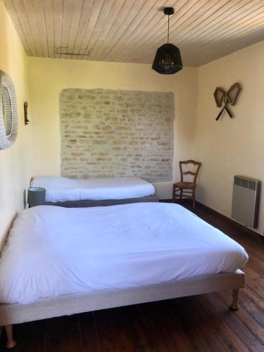 Ein Bett oder Betten in einem Zimmer der Unterkunft L'ILEAU