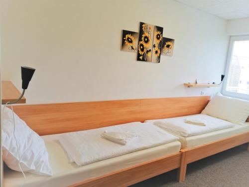 a bed in a room with a wooden frame at Penzion Adriana in Nové Mesto nad Váhom