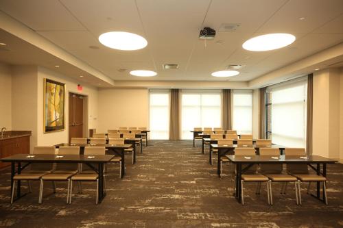 a classroom with tables and chairs in a room at Holiday Inn Express & Suites - Charlotte - South End by IHG in Charlotte