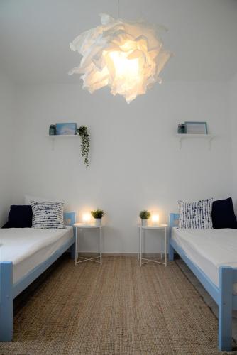 a room with two beds and two tables with candles at Casa di Felicita in Biograd na Moru