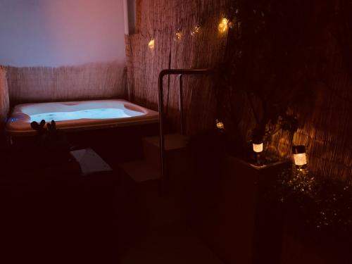 a bathroom with a bath tub in a dark room at Palazzo Otello 1847 Wellness & Spa in Vicenza