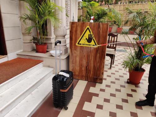 a sign on a door with a suitcase in a building at Laxmi Palace Heritage Boutique Hotel in Jaipur