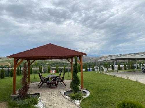 a gazebo with a table and chairs in a park at Kostovski Rooms-near E75 to Greece in Veles