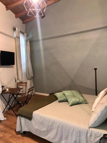 a bedroom with a bed and a chandelier at L'Iris B&B in Terrazza in Lucca
