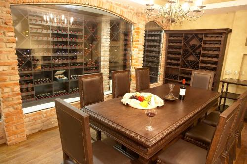a dining room with a table and a wine cellar at Hotel VEGA Sofia in Sofia