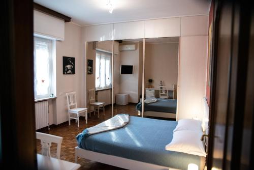 a bedroom with a bed and a mirror at La Corte di Aldo in Rozzano