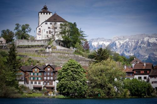 a building on top of a hill with a castle at b-smart motel Sevelen in Sevelen