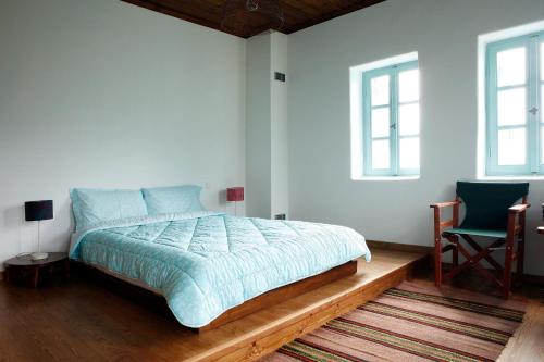 Ένα ή περισσότερα κρεβάτια σε δωμάτιο στο Ξενώνας Ρίζες