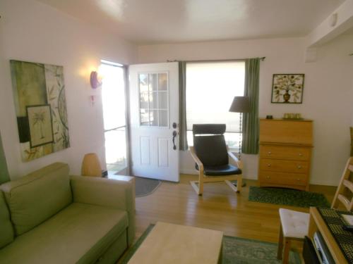 a living room with a couch and a chair at Blue Heron Cottages in San Diego