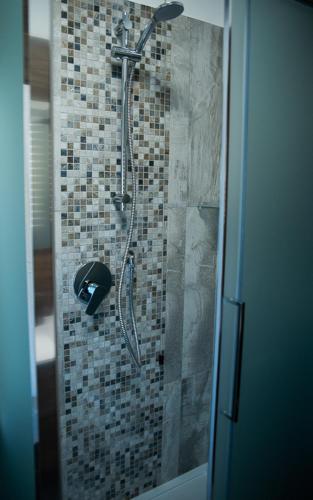 a shower in a bathroom with a glass door at La Corte di Aldo in Rozzano