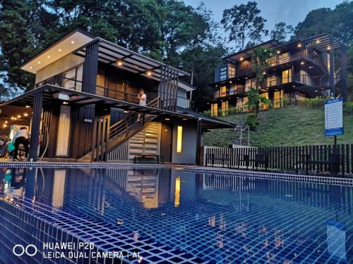 a building with a swimming pool in front of a building at Casa Hill Resort in Sungai Lembing