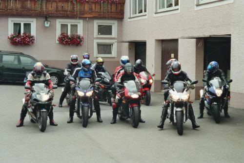 a group of people riding motorcycles in a parking lot at Hotel Restaurant Zum Hirschen in Donaueschingen
