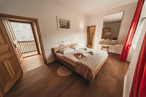a bedroom with a large bed and a bathroom at Rooms & Apartments Podsreda Castle in Podsreda