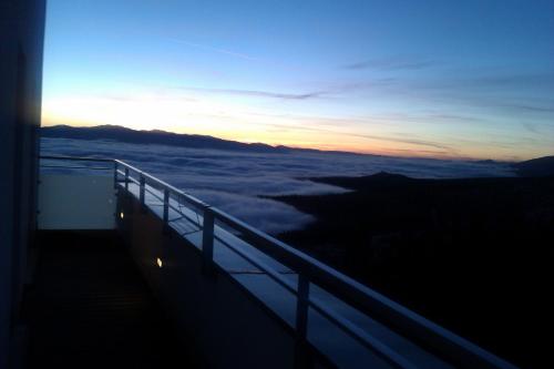 a view of the sunset from the balcony of a building at Apartman Panorama 1001 in Štrbské Pleso