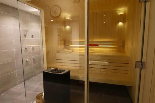 a shower with a glass door in a bathroom at Le Chalet in Peisey-Nancroix