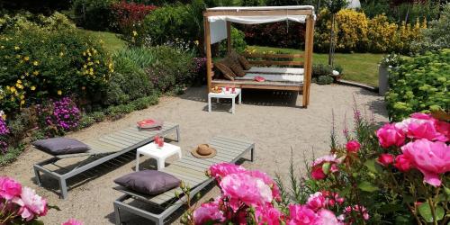 a garden with a bench and a gazebo and flowers at La Collina since 2008 NO SMOKING B&B in Varese