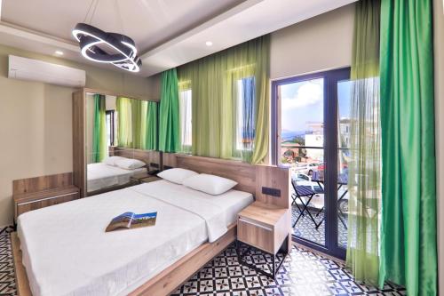 a hotel room with a bed and a balcony at Zeytin HOTEL in Kaş