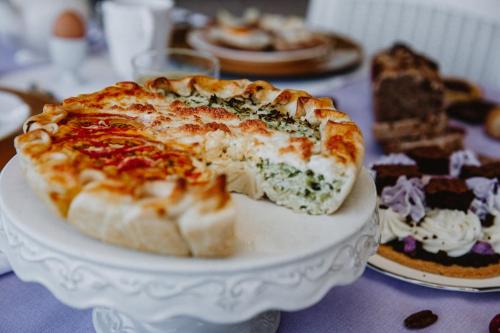 a pizza on a plate on a table with other desserts at Alle Pendici del Conero in Sirolo