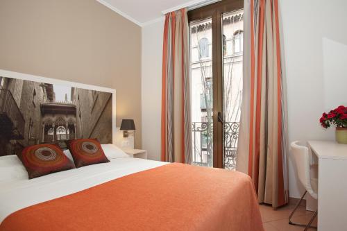 a bedroom with a bed and a large window at BCNGOTIC 33 in Barcelona