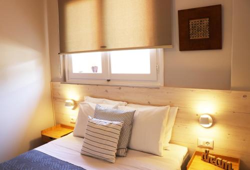 A bed or beds in a room at HABITAT Nafplio bnb - Design Apartment