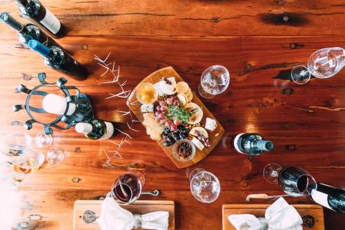 a table with a plate of food and wine glasses at Shumbalala Game Lodge in Thornybush Game Reserve