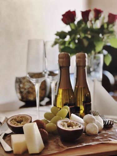 a table with two bottles of wine and some cheese at Örums Nygård Gårdshotell in Löderup