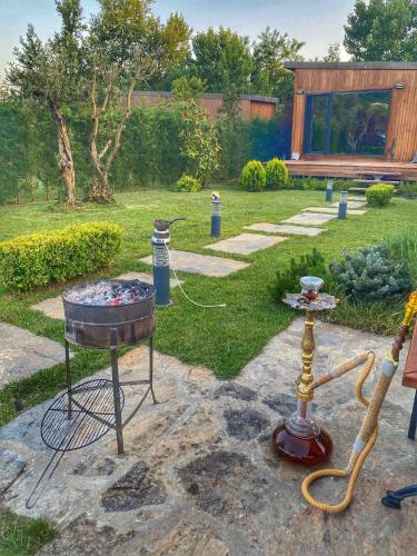 a garden with a grill and a bbq smoker at Pamera Garden Hotel in Kılıçlı