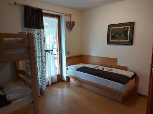 A bed or beds in a room at CHALET VILLA RITA