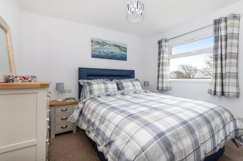 a bedroom with a bed and a window at 40 Norton Park in Dartmouth